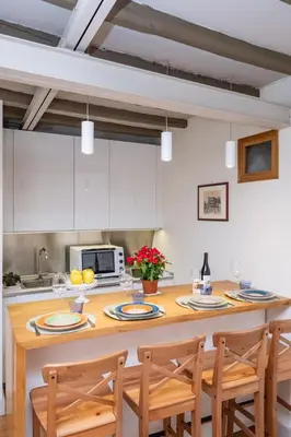 a kitchen with a large wooden table with chairs at Casa Di Armando al Pantheon in Rome