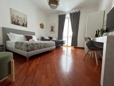 a bedroom with a bed and a living room at Domus Vittoria in Rome