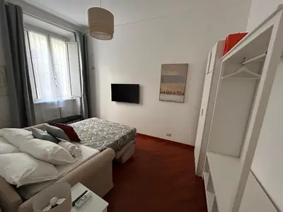 a small bedroom with a bed and a television at Domus Vittoria in Rome