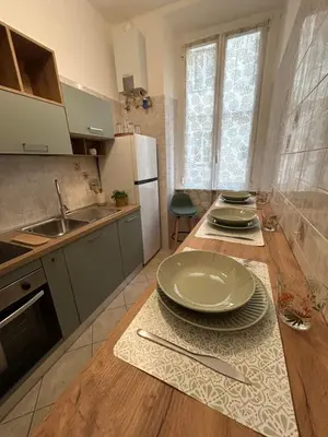 a kitchen with a table with plates on it at Domus Vittoria in Rome