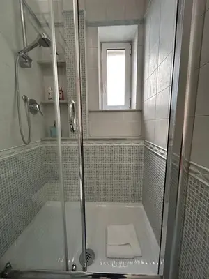 a shower with a glass door in a bathroom at Domus Vittoria in Rome