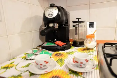 a coffee maker and two cups on a kitchen counter at Little House Roma in Rome