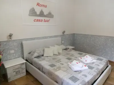 a bedroom with a bed with towels on it at Little House Roma in Rome
