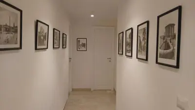 a hallway with a bunch of pictures on the walls at Bella Roma Stay in Rome