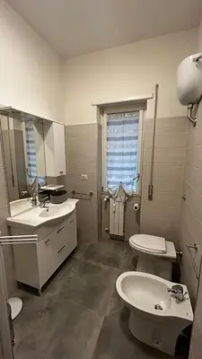 a bathroom with a sink and a toilet and a mirror at Bella Roma Stay in Rome