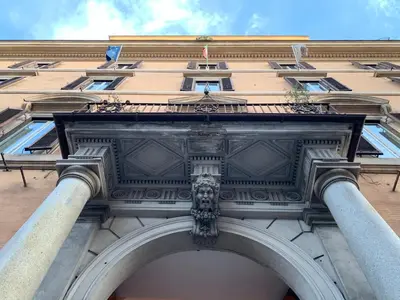 a facade of a building with a statue on it at Luxury Suite Monti Quirinale in Rome