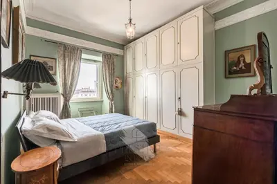 a bedroom with a bed and a lamp and a dresser at New! Una Finestra su San Pietro in Rome
