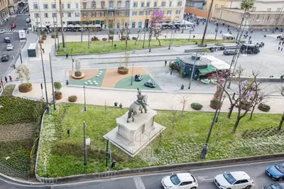 a statue in a park in a city with cars at New! Una Finestra su San Pietro in Rome