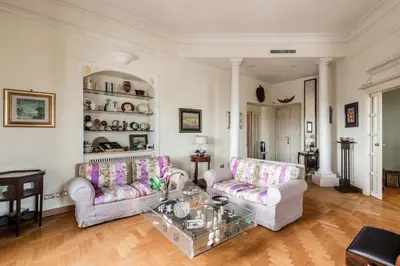 a living room with two couches and a glass table at New! Una Finestra su San Pietro in Rome