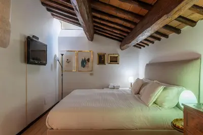 a bedroom with a bed and a tv on the wall at Orange Room with bathroom and Shared Terrace in Rome