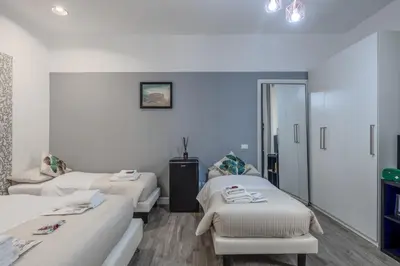 a hospital room with three beds and a mirror at Turati maison d'hotes in Rome
