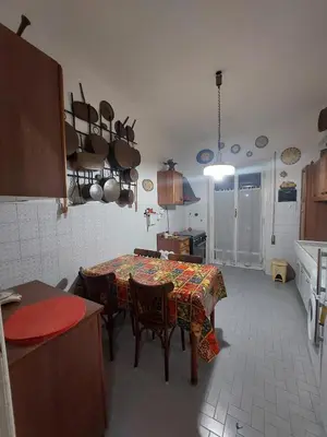a kitchen with a table and some pots and pans at La Casa Dei Nonni al Vaticano in Rome
