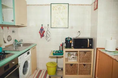 a kitchen with a sink and a washing machine at La Casetta del '32 in Rome