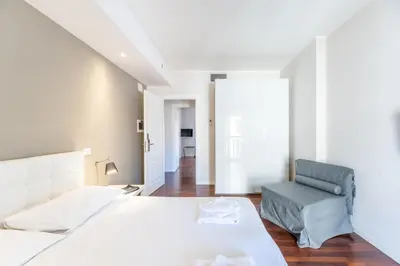 a bedroom with a bed and a chair at Vatican Pixel Apartments in Rome
