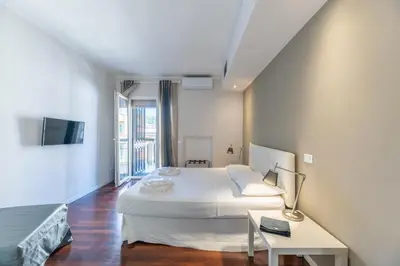 a bedroom with a bed and a table and a tv at Vatican Pixel Apartments in Rome