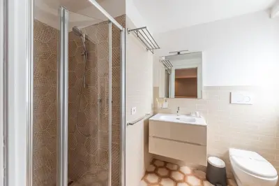 a bathroom with a toilet and a sink and a shower at Vatican Pixel Apartments in Rome