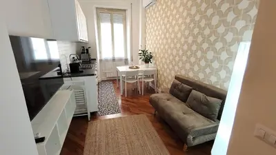 a living room with a couch and a table at La Casa Di Elda - 2 Camere - Metro B in Rome