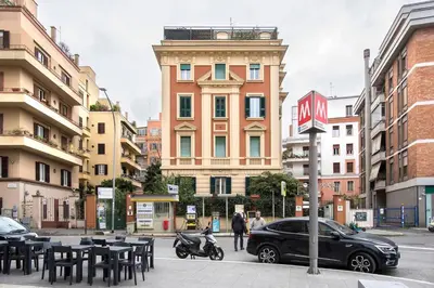 a black car parked in front of a building at La Casa Di Elda - 2 Camere - Metro B in Rome