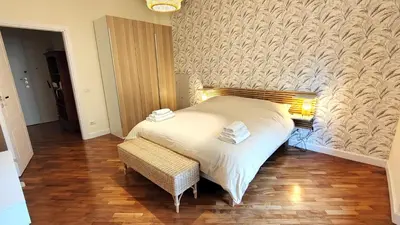 a bedroom with a bed and a bench and a wall at La Casa Di Elda - 2 Camere - Metro B in Rome