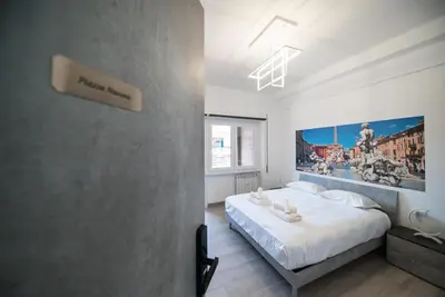 a bedroom with a bed and a painting on the wall at Domus Garbatella in Rome