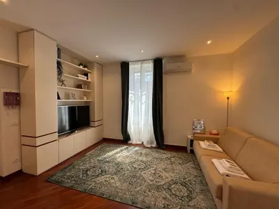 a living room with a couch and a large window at St John Apartment in Rome in Rome