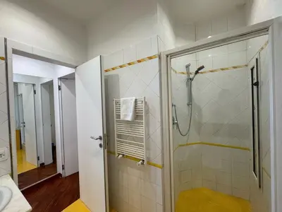 a bathroom with a shower with a glass door at St John Apartment in Rome in Rome