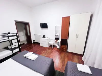 a bedroom with a bunk bed and a dresser at Roma Comfort Inn in Rome