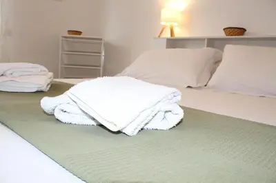 a bedroom with two white towels on a bed at Interno 10 in Rome