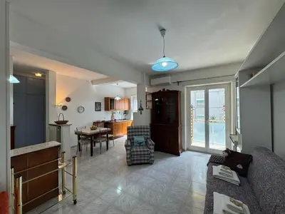 a living room with a couch and a dining room at Studio in the Green Roma in Rome