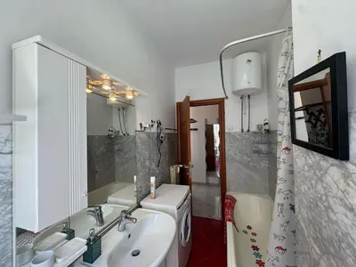 a bathroom with a sink and a shower and a tub at Studio in the Green Roma in Rome