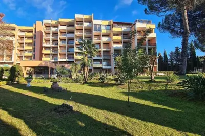 a large apartment building with a park in front of it at TatyHouse in Rome