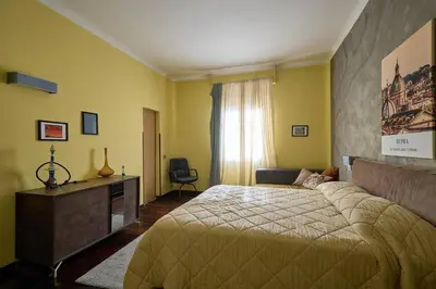 a bedroom with a large bed and a window at Casa Tembien in Rome in Rome
