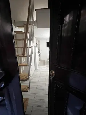a hallway with a staircase and a black door at Machiavelli's House in Rome