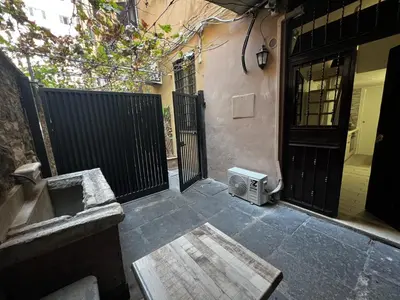 a patio with a door and a table and a house at Machiavelli's House in Rome