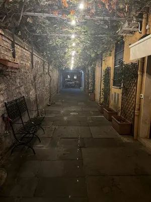 an empty alley with a bench in a building at Machiavelli's House in Rome