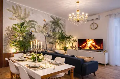 a white bedroom with a bed and a chandelier at Mami Garden in Rome