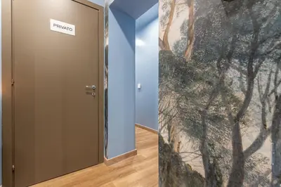 a hallway with a door with a painting on the wall at Guest House Colosseo Terrestre in Rome