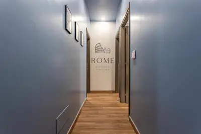 a hallway with a row of doors and a sign at Guest House Colosseo Terrestre in Rome