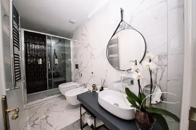 a white bathroom with a sink and a mirror at Piazza di spagna 32 Fellini Design Suites in Rome