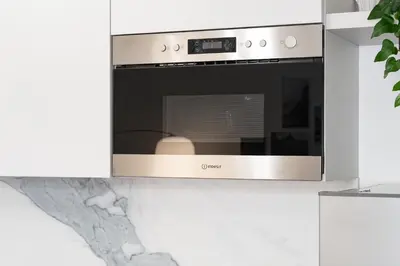 a stainless steel oven in a white kitchen at BMGA l Poppy's Home Attic Vaticano in Rome