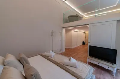 a living room with a couch and a flat screen tv at Heart of Rome - Pantheon View in Rome