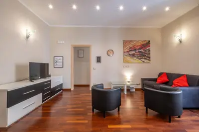 a living room with a couch and a tv at Trevi Fountain big apartment in Rome