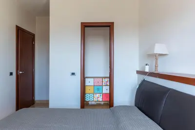 a bedroom with a bed and a door with a lamp at GuestHost - Bright Apartment in Monteverde in Rome