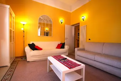 a living room with a couch and a table at Mameli Holiday House in Rome