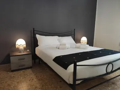 a bedroom with a bed with two lamps on it at Silvia Apartment in Rome