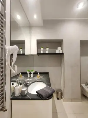 a bedroom with two beds with green pillows at Rome in Style Colosseum in Rome