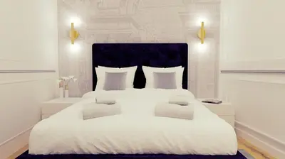a bedroom with a large white bed with two pillows at Apartament Leutari in Rome
