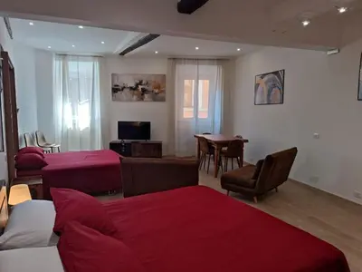 a room with three beds and a table and a couch at Ottavia apartment in Rome