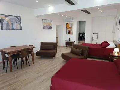 a living room with a bed and a table and chairs at Ottavia apartment in Rome
