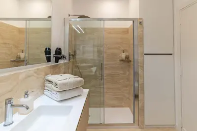 a bathroom with a shower and a white sink at Baglivi 8 - Sapienza - Metro B in Rome